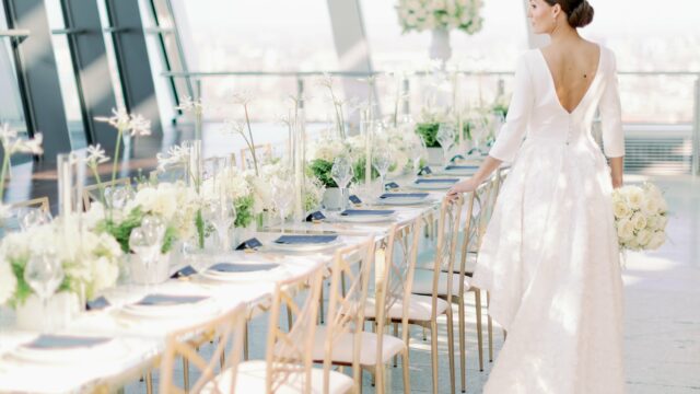 Camilla Joy Photography. Bride wearing modern open back dress. All white wedding table.