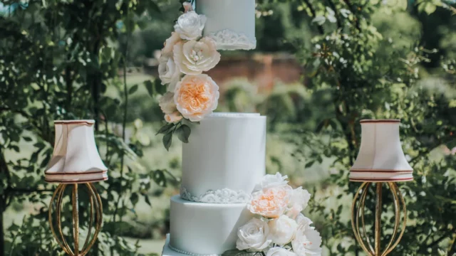 Cake Designer: RT Cakes. Pastel blue and blush orange wedding cake, 4 tiers. Alice in wonderland cake.
