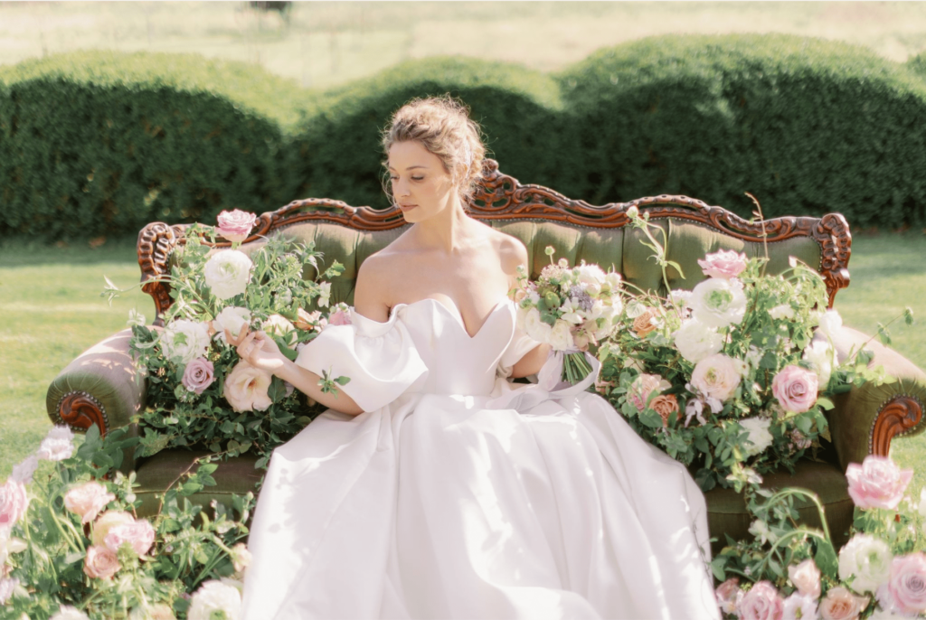 beautiful bride sitting in an enchanted garden of Sudeley Castle